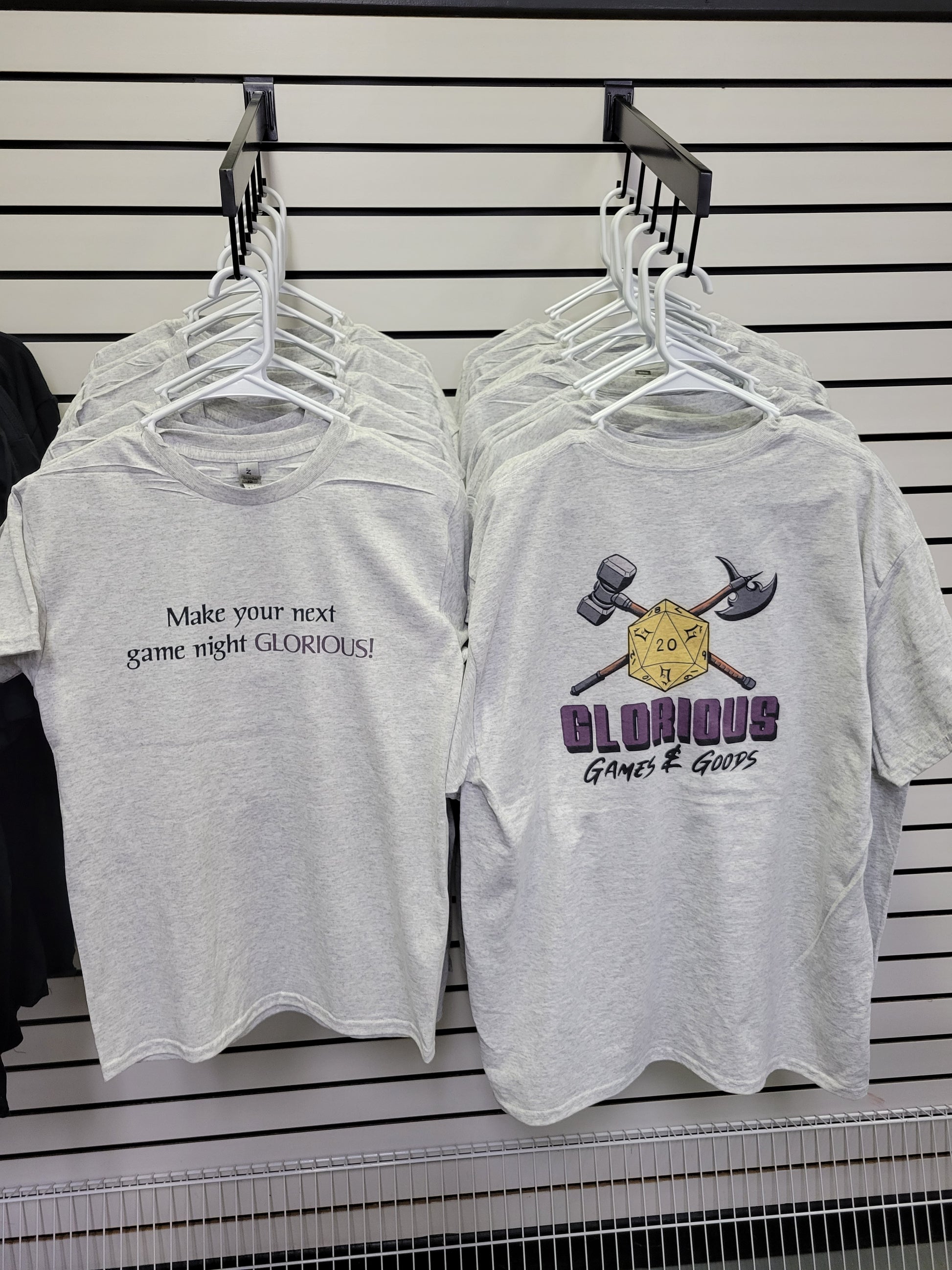 Front and back of our store t shirt! Front says "make your next game night Glorious" and the back features our logo!